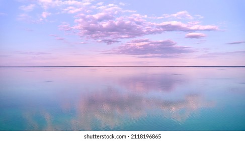Stunning pink-purple sunrise on the Kiev Sea. Seascape with azure water and purple clouds in reflection. Tourism and recreation. - Shutterstock ID 2118196865