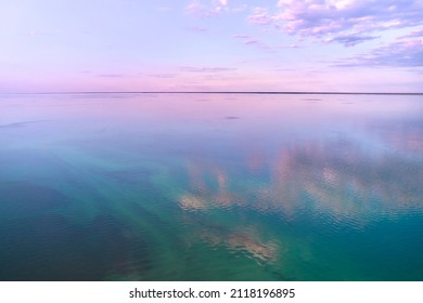 Stunning pink-purple sunrise on the Kiev Sea. Seascape with azure water and purple clouds in reflection. Tourism and recreation. - Shutterstock ID 2118196895