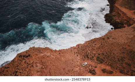 Stunning red cliffs at Quobba Station, Western Australia, with waves crashing on remote beaches. Perfect for 4WD adventure, camping, and exploring caves, cliffs, and ocean reflections in the outback - Powered by Shutterstock