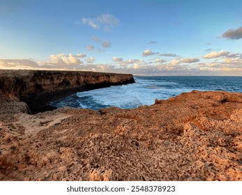 Stunning red cliffs at Quobba Station, Western Australia, with waves crashing on remote beaches. Perfect for 4WD adventure, camping, and exploring caves, cliffs, and ocean reflections in the outback - Powered by Shutterstock