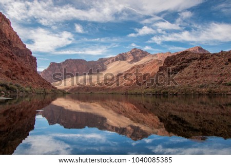 Stunning red rock reflection on the Colorado river near Glen Canyon recreation area and Lees Ferry in Arizona.