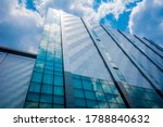 Stunning reflection of clouds on a glass and aluminum facade of an office building in Metro Manila. Location in Anonas, Quezon City.