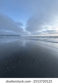 Stunning reflective beach scape with dramatic sky
