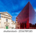 The stunning San Rocco facade contrasts with the vibrant red cube of the Ara Pacis museum in Rome, showcasing architectural beauty.