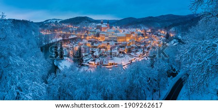 Stunning scenic view of beautiful cityscape of medieval Loket nad Ohri town with Loket Castle gothic style on massive rock, colorful buildings during winter season, Karlovy Vary Region, Czech Republic