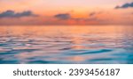 Stunning scenic view of endless ocean water surface with horizon line under defocus bright colorful sunset sky in evening time. Dream inspirational nature pattern, seascape skyline tranquil background