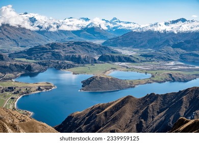 Stunning scenic views of the bays of Lake Wanaka and the snow capped Southern Alps from the Roys Peak mountain track  