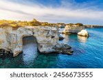 Stunning seascape with cliffs rocky arch and stacks (Faraglioni) at Torre Sant Andrea, Salento coast, Puglia region, Italy. Beautiful cliffs and sea stacks of Sant