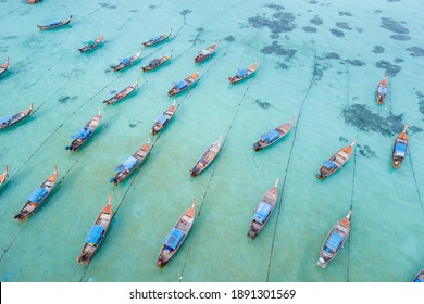 Stunning summer landscape. Aerial view of fishing long tail boat group in turquoise Andaman sea at Koh Lipe or Lipe island, Satun, Southern Thailand. Shot from drone