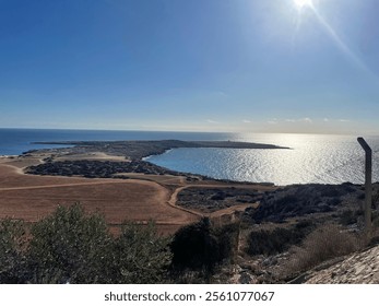 A stunning sunlit view of Cavo Greco in Ayia Napa, Cyprus. The sparkling Mediterranean Sea and rugged coastal landscapes create a breathtaking scene, perfect for nature and travel lovers. - Powered by Shutterstock