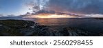 A stunning sunrise illuminates the rocky shoreline of Vancouver Island, BC, Canada, showcasing vibrant colors and a serene coastal ambiance.