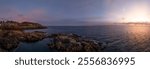 A stunning sunrise over the rocky coastline of Victoria, Vancouver Island, BC. The golden light reflects on the ocean, creating a serene and peaceful atmosphere.