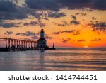 Stunning sunset with dramatic clouds over Michigan City East Pierhead Lighthouse, Washington Park Beach, Michigan City, Indiana