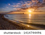 Stunning sunset with dramatic clouds over Michigan City East Pierhead Lighthouse, Washington Park Beach, Michigan City, Indiana