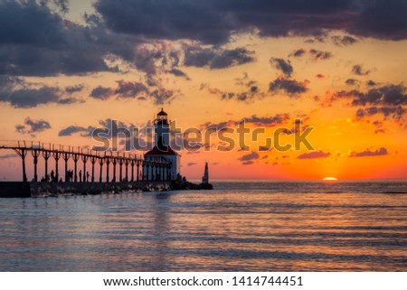 Stunning sunset with dramatic clouds over Michigan City East Pierhead Lighthouse, Washington Park Beach, Michigan City, Indiana