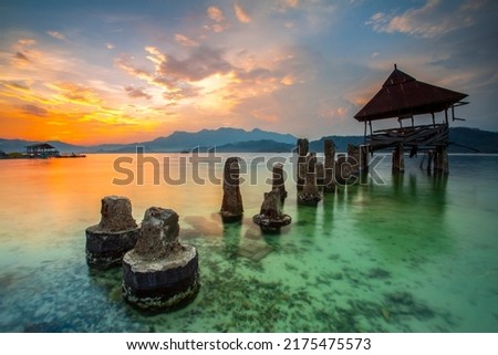 stunning sunset on the beach Tanjung Putus Lampung Indonesia. building by the beach. Indonesian landscapes tropical beaches.
