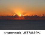 Stunning sunset over the Atlantic Ocean, vibrant sky with hues of yellow and magenta, dramatic clouds, serene seascape, ocean waves reflecting warm colors, golden hour, romantic and peaceful atmospher