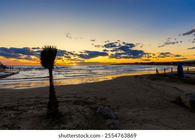 A stunning sunset over a coastal promenade with dramatic clouds in the sky, calm ocean waves, and distant city lights, creating a serene and picturesque scene perfect for stock photography - Powered by Shutterstock