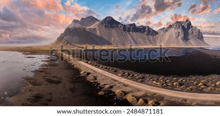 Stunning sunset over the dramatic peaks of Vestrahorn mountain and black sand dunes at Stokksnes Peninsula, Iceland.
