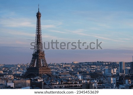 A stunning sunset view of the Eiffel Tower and nearby buildings in Paris, France