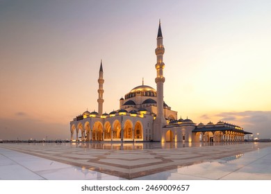 Stunning sunset view of the Sharjah New Mosque, showcasing its breathtaking architecture and intricate design. A must-visit tourism spot in Dubai