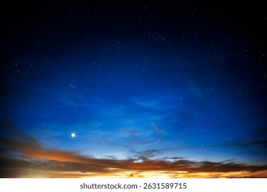 A stunning transition from sunset to night with vibrant colors, scattered stars, and a bright celestial object near the horizon.