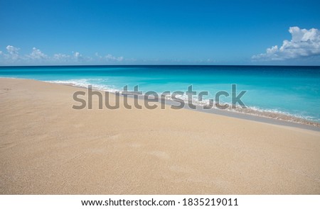 Stunning turquoise Caribbean Sea waters and sandy beach on a sunny day at Sandy Point on St. Croix in the US Virgin Islands