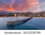 Stunning vibrant sky over Ventura beach with a long pier at sunset, California, USA