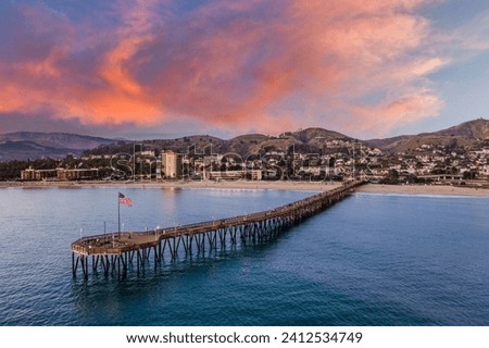 Stunning vibrant sky over Ventura beach with a long pier at sunset, California, USA
