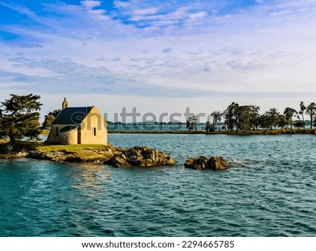 Stunning view of Boedic Island and its famous chapel at sunset, Morbihan Gulf, Brittany, France
