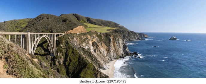 A stunning view of a bridge on the ocean coast at Big Sur, California, offering a scenic backdrop for a road trip adventure - Powered by Shutterstock