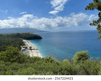 A stunning view of Bugbug Beach in Karangasem, Bali, featuring turquoise waters, lush greenery, and a serene coastline. A perfect tropical escape for nature lovers and beachgoers seeking tranquility. - Powered by Shutterstock