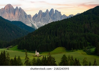 Stunning view of the Church of St. John (San Giovanni in Ranui ) that stands out in the green meadows, in the heart of the beautiful Dolomitic mountain landscape.