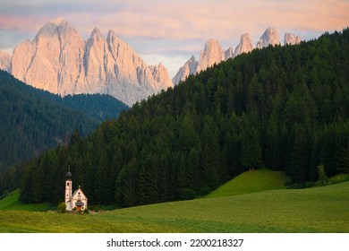 Stunning view of the Church of St. John (San Giovanni in Ranui ) that stands out in the green meadows, in the heart of the beautiful Dolomitic mountain landscape
