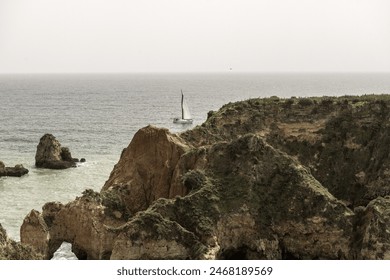 Stunning view of coastal rock formations and sea arches in Portimao, Portugal. The rugged cliffs and scattered sea stacks create a dramatic and picturesque seascape. - Powered by Shutterstock