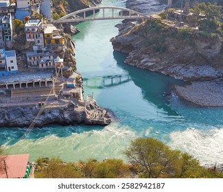 A stunning view of Devprayag Sangam  in District tehri Garhwal, Uttarakhand, where the Alaknanda and Bhagirathi rivers merge, forming the holy Ganga, surrounded by scenic hills and temples.

