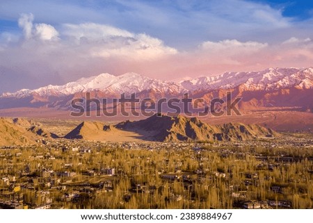 Stunning view of evening light that shines down onto the mountain sky, clouds,valleys and city of Leh from above. Ladakh,India.