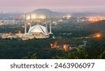 A Stunning view of Faisal Mosque, Islamabad, Pakistan. Modern Islamic architecture nestled against the Margalla Hills, showcasing its unique geometric design and serene ambiance.