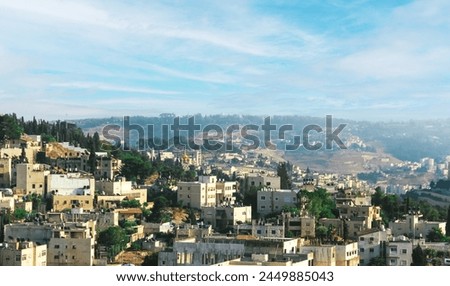 A stunning view of Jerusalem, Israel, showcasing the citys architectural beauty against a backdrop of majestic hills and lush greenery. Experience the peaceful ambiance of this historic city.