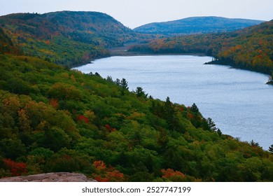 Stunning view of the lake within Porcupine Mountains Wilderness State Park, Michigan, captured from the mountain top, showcasing the vast expanse of water surrounded by dense forest. Ideal for nature  - Powered by Shutterstock