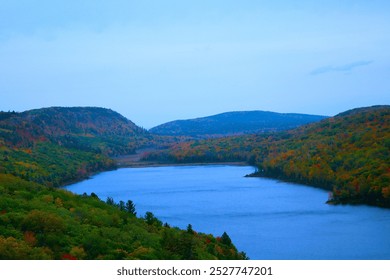 Stunning view of the lake within Porcupine Mountains Wilderness State Park, Michigan, captured from the mountain top, showcasing the vast expanse of water surrounded by dense forest. Ideal for nature  - Powered by Shutterstock