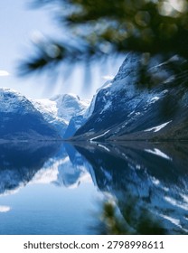 A stunning view of a large glacier with sharp icy peaks and blue ice formations in a mountain setting.