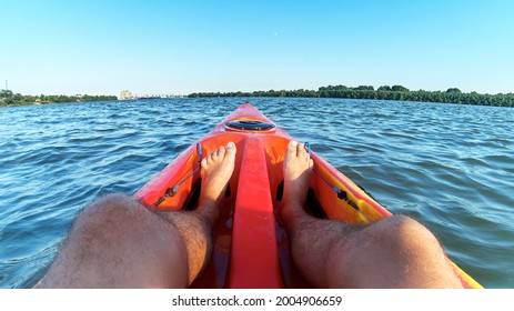 Stunning View Of Man's Bare Legs In A Kayak In A Orange Kayak In The Danube River