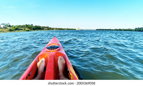 Stunning View Of Man's Bare Legs In A Kayak In A Orange Kayak In The Danube River