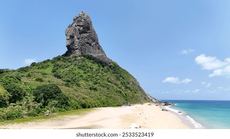 A stunning view of Morro do Pico on Fernando de Noronha island with a pristine beach and clear blue sky. - Powered by Shutterstock