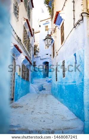 Stunning view of a narrow alleyway with the striking, blue-washed buildings. Chefchaouen, or Chaouen, is a city in the Rif Mountains of northwest Morocco. Stock fotó © 