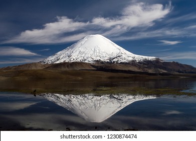 Stunning View Of The Parinacota Volcano Reflected In Water Of Chungará Lake