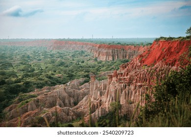 Stunning view of the red cliffs and unique rock formations in Angola's lush landscape under the expansive sky