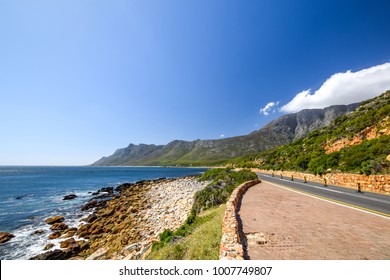 Stunning view of Route 44 in the eastern part of False Bay near Cape Town between Gordon's Bay and Pringle Bay. Hottentots Holland Mountain range in the background. Viewpoint parking bay on right. - Shutterstock ID 1007749807