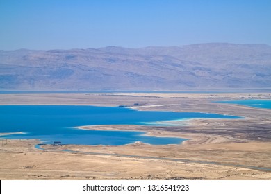 Stunning view of salt deposits and turquoise water of the Dead Sea and Judean Desert in Israel with Jordan mountains in background